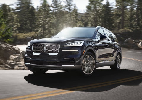 A Lincoln Aviator® SUV is being driven on a winding mountain road | Hines Park Lincoln in Plymouth MI