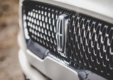 The grille of the 2024 Lincoln Aviator® Reserve model with an eye-catching repeated field of Lincoln Star logo shapes | Hines Park Lincoln in Plymouth MI