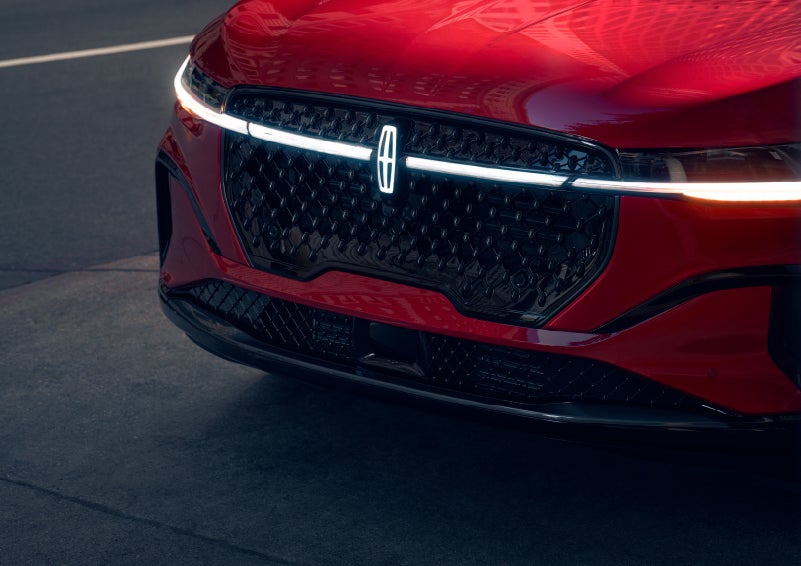 The available front LED light bar and center Lincoln Star logo glow at dusk. | Hines Park Lincoln in Plymouth MI