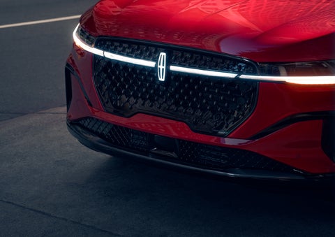 The available front LED light bar and center Lincoln Star logo glow at dusk. | Hines Park Lincoln in Plymouth MI