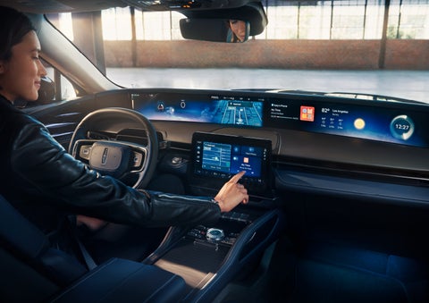 The driver of a 2025 Lincoln Nautilus® SUV interacts with the center touchscreen. | Hines Park Lincoln in Plymouth MI