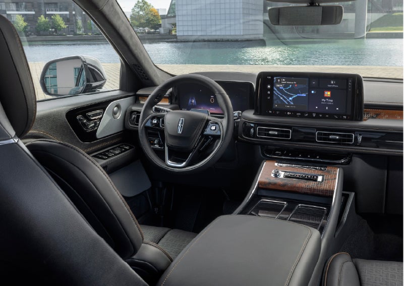 The interior of the 2026 Lincoln Aviator® SUV is shown parked with a view of a harbor through the windshield. | Hines Park Lincoln in Plymouth MI