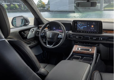 The interior of the 2026 Lincoln Aviator® SUV is shown parked with a view of a harbor through the windshield. | Hines Park Lincoln in Plymouth MI
