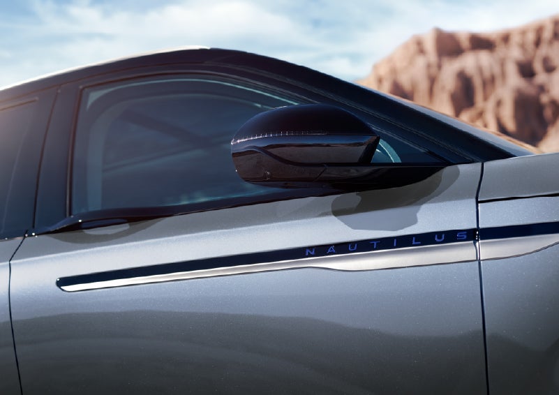 Blue lettering on the side of the vehicle that reads Nautilus indicates the available Hybrid Powertrain. | Hines Park Lincoln in Plymouth MI