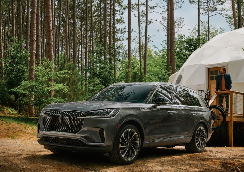 A 2027 Lincoln Aviator® is parked next to a high end glamping site. | Hines Park Lincoln in Plymouth MI