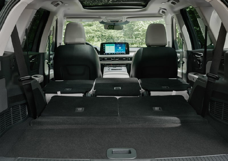 A rear to front view of the interior of a 2027 Lincoln Aviator® Black Label™ SUV shows the third and second rows folded flat | Hines Park Lincoln in Plymouth MI