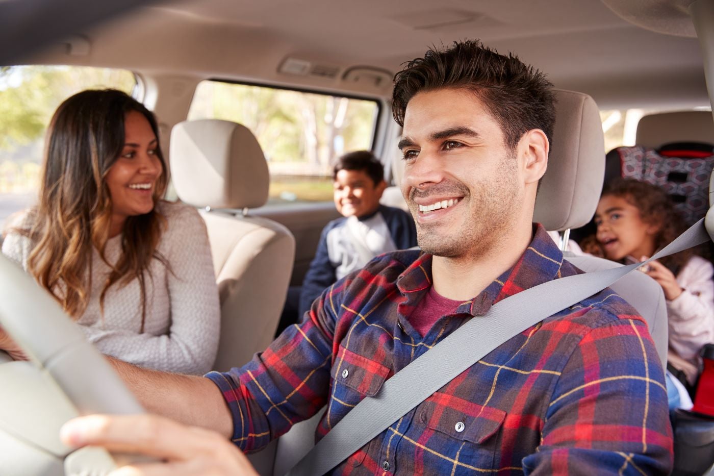 Family smiling in Lincoln vehicle driving around on an adventure around Canton, Michigan
