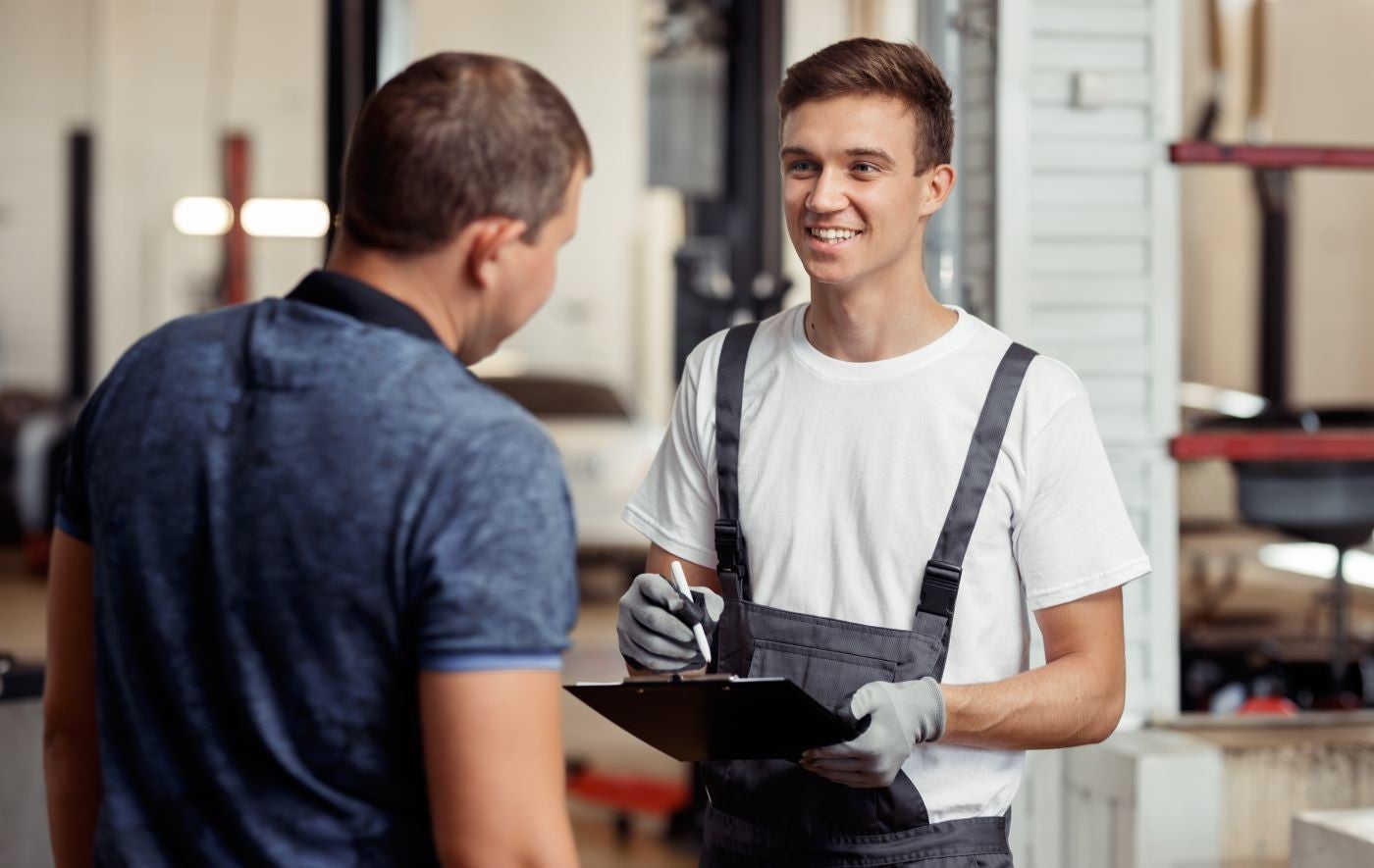 Lincoln Certified Technician reviewing maintenance schedules with customer
