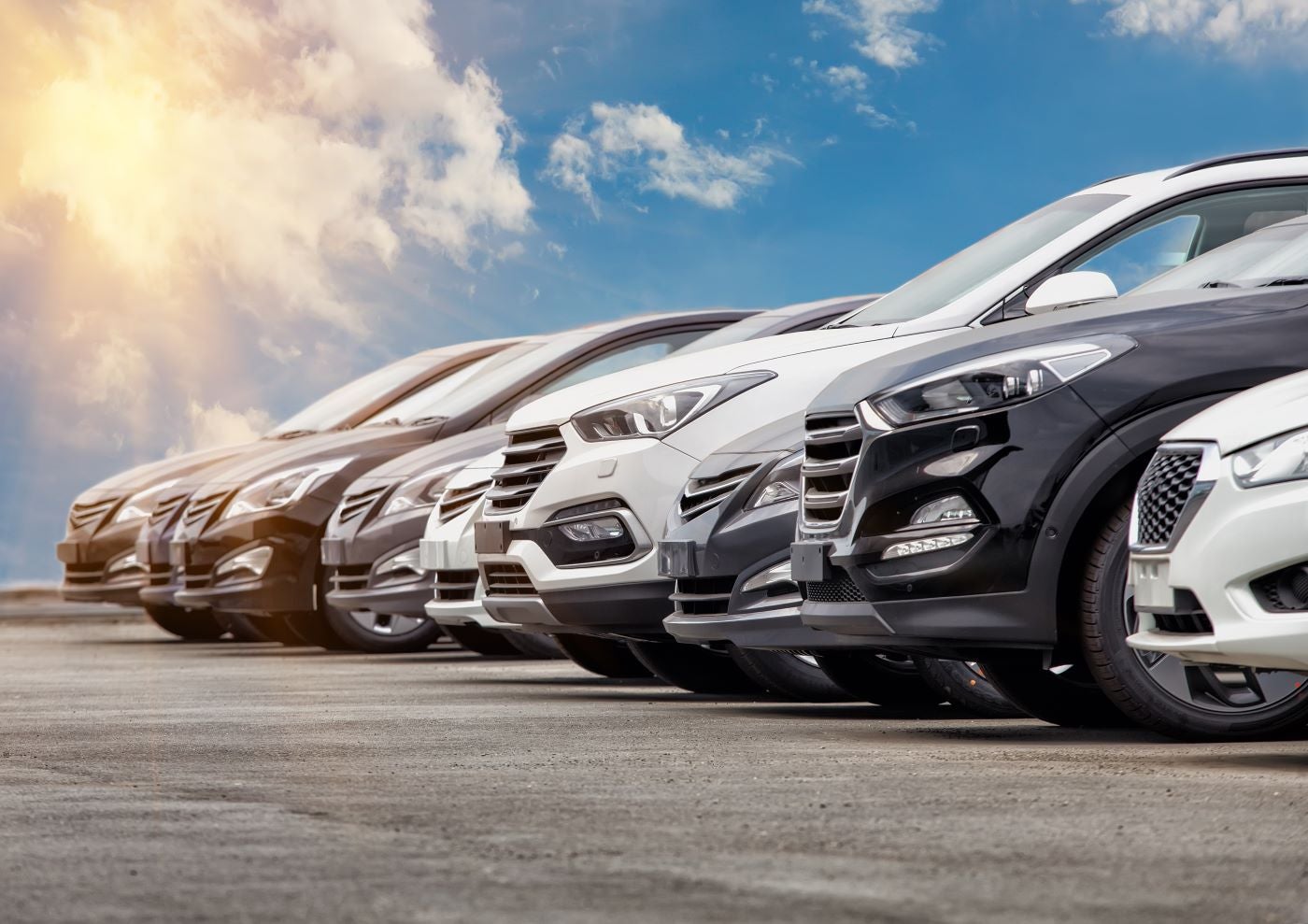 Lineup of Lincoln vehicles with sunny sky in the background