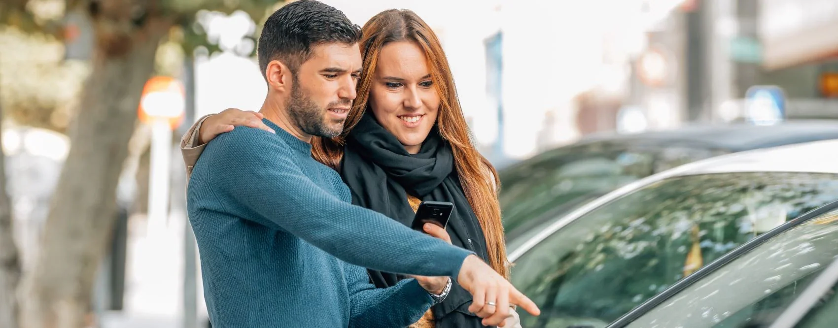 Couple looking at car options at Hines Park Lincoln Dealer FAQ