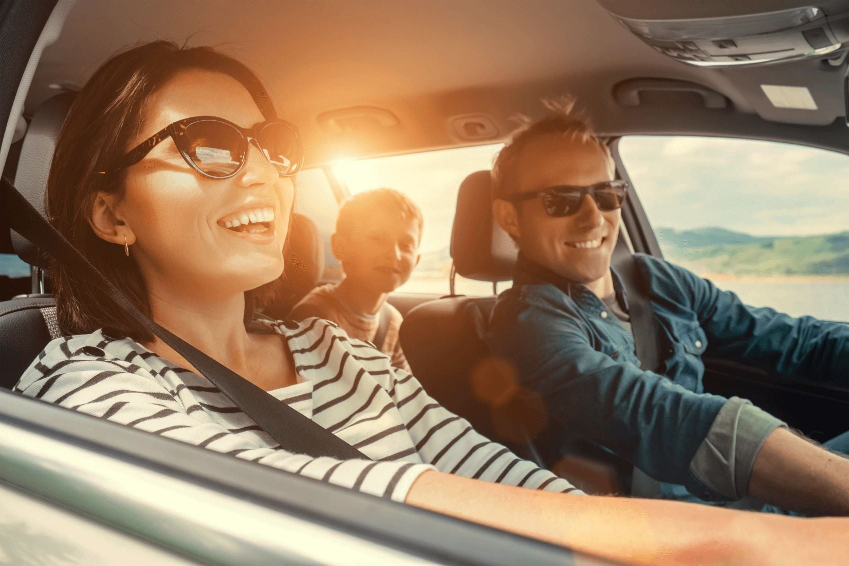 Family smiling while driving in their Lincoln vehicle