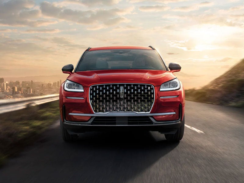 Front view of Lincoln Corsair driving with city in background from Lincoln Corsair lease specials at Hines Park Lincoln