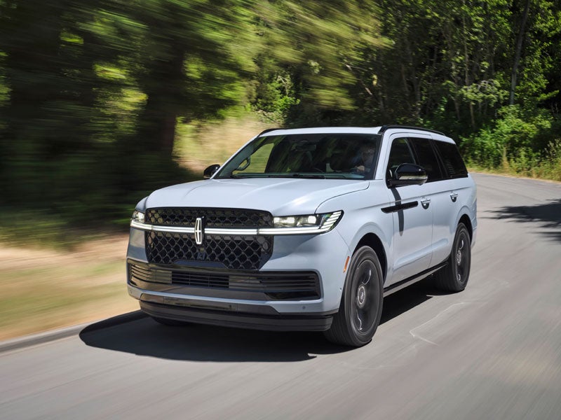 Lincoln Navigator driving through woods with motion blur from Lincoln Navigatory lease specials near Plymouth, Wixom, and Brighton MI